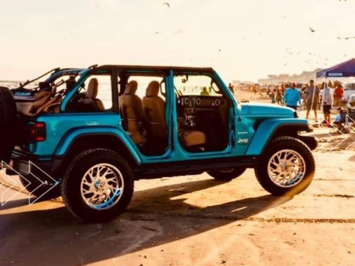 a blue truck parked next to a car