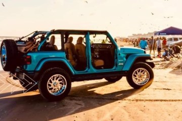 a blue truck parked next to a car